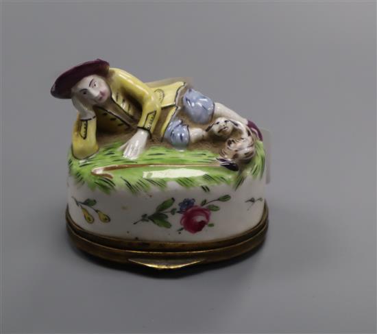 A Continental porcelain snuff box, modelled as a recumbent shepherd, height 6.5cm